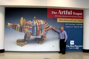 Sonny Kamm at the Charlotte Douglas airport with marketing for the Mint Museum exhibition in North Carolina.