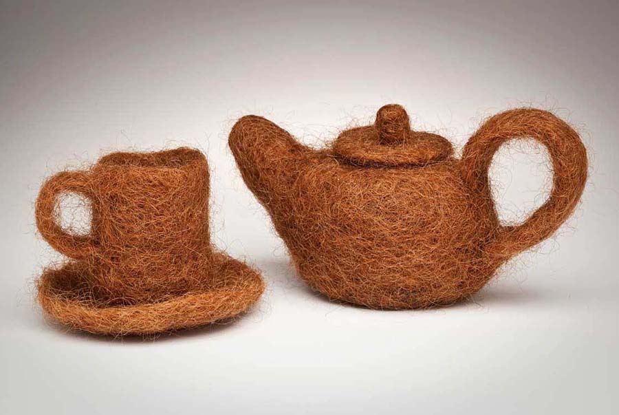 Annin Barrett, a teapot and cup made of her red hair.