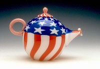 A tea pot with the american flag painted on it.