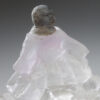 A small statue of a gorilla in a dress