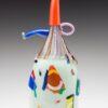 A glass bottle with colorful shapes on it.