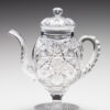 A glass teapot with a lid on top of it.