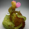 A green and brown object with pink flowers.