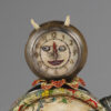 A clock with horns on top of it.