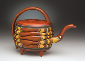 A wood teapot sculpture by Terry Evans.