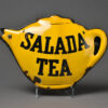 A yellow tea pot with the words salada tea written on it.