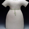 A white dress with green trim is shown.