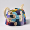 A teapot made of colorful tiles with handles.