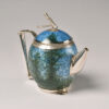 A blue and green teapot with silver handles.