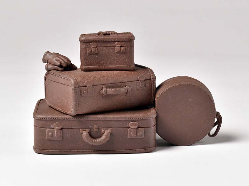 Kathryn McBride, a ceramic teapot sculpture of stacked suitcases.